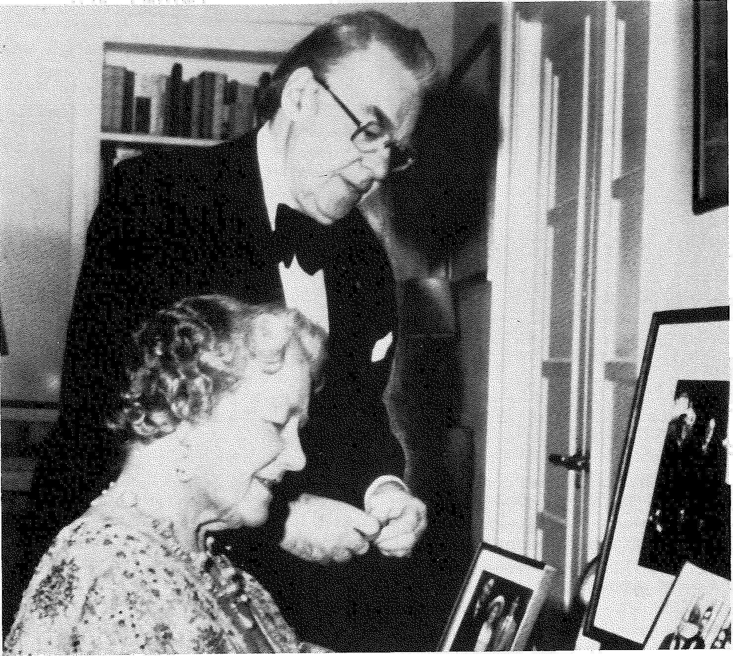 As Ambassador in England, Martin watches as Queen Mother signs the Official Residence guest register.