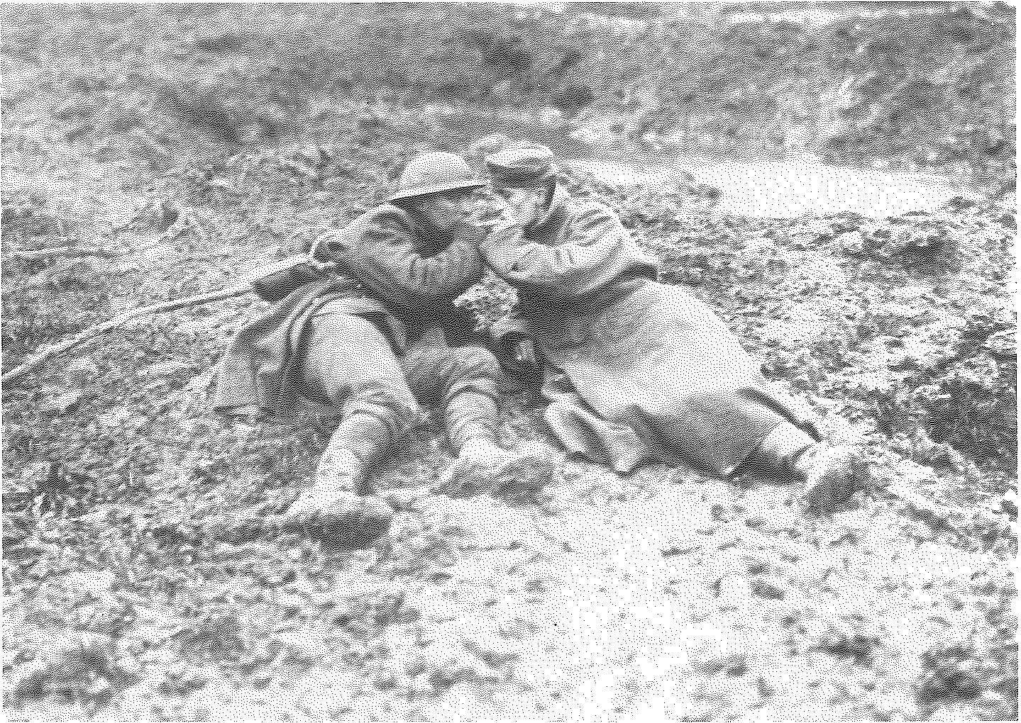 A wounded Canadian and wounded German in the mud on Passchendaele, light up, November 1917