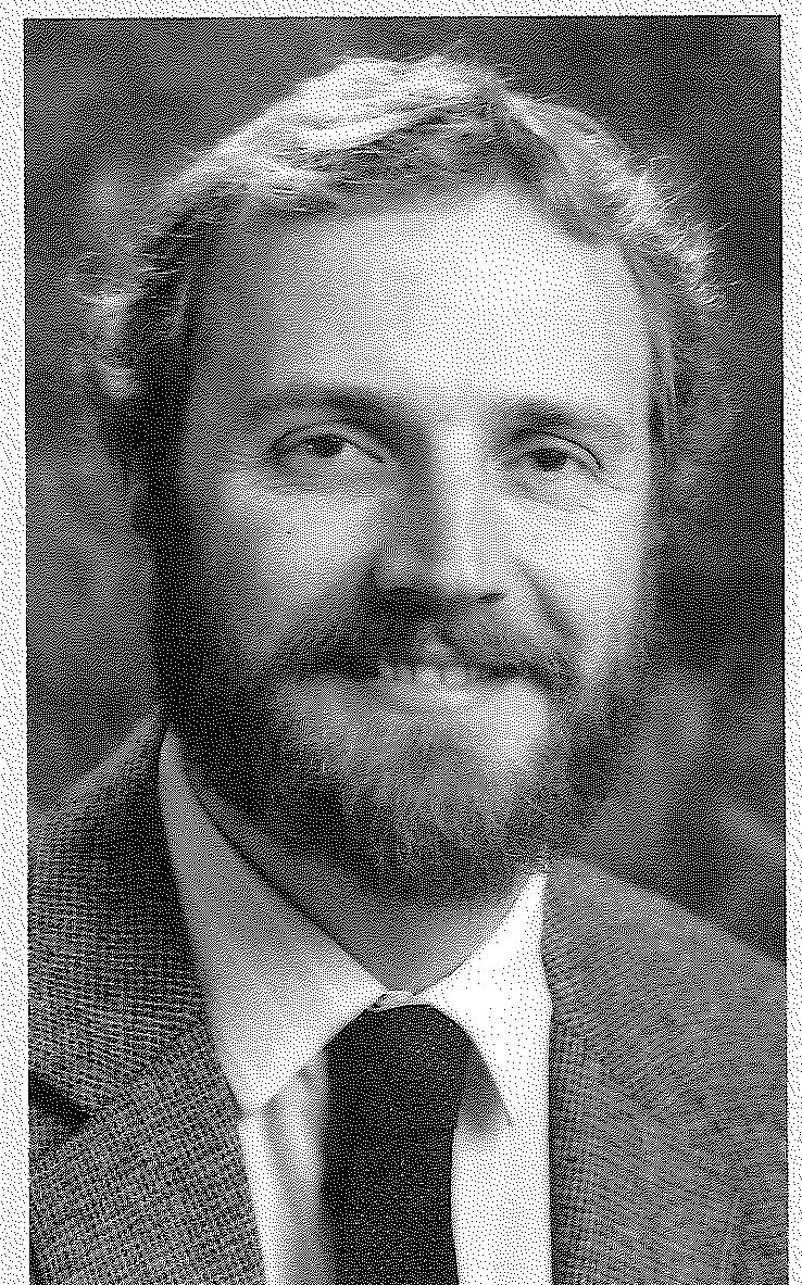 Head-and-shoulders portrait of a bearded man in a tweed jacket and dark tie.