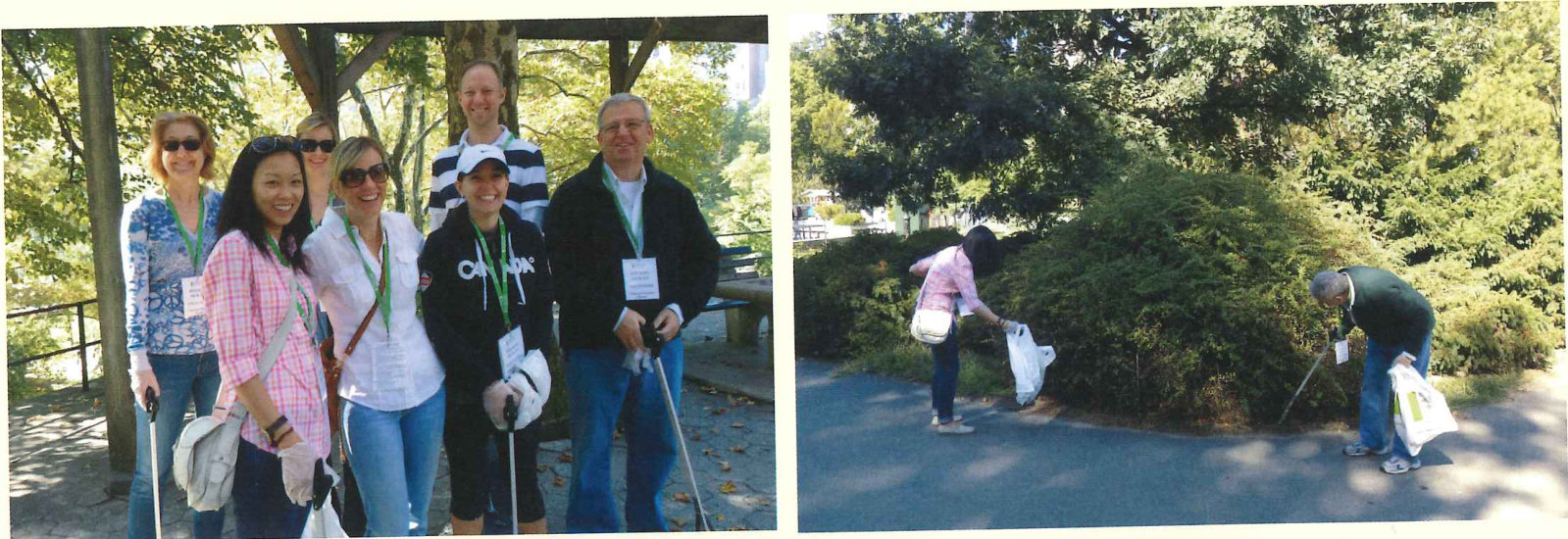 Volunteers in lanyards gather on a park path, and one bags litter among the trees.
