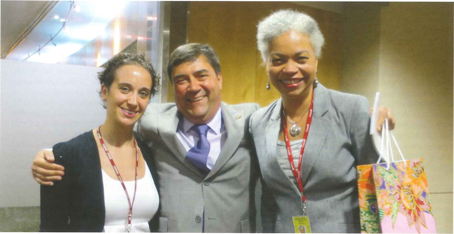 Two officers standing either side of Deputy Minister Daniel Jean at a reception