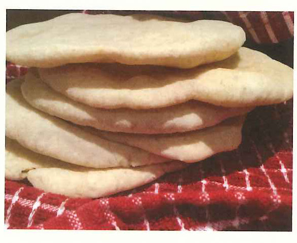 A stack of flatbreads on a red checked cloth