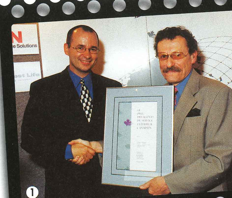 Fred Bild (right) presenting Award to Louis Dumas (left).