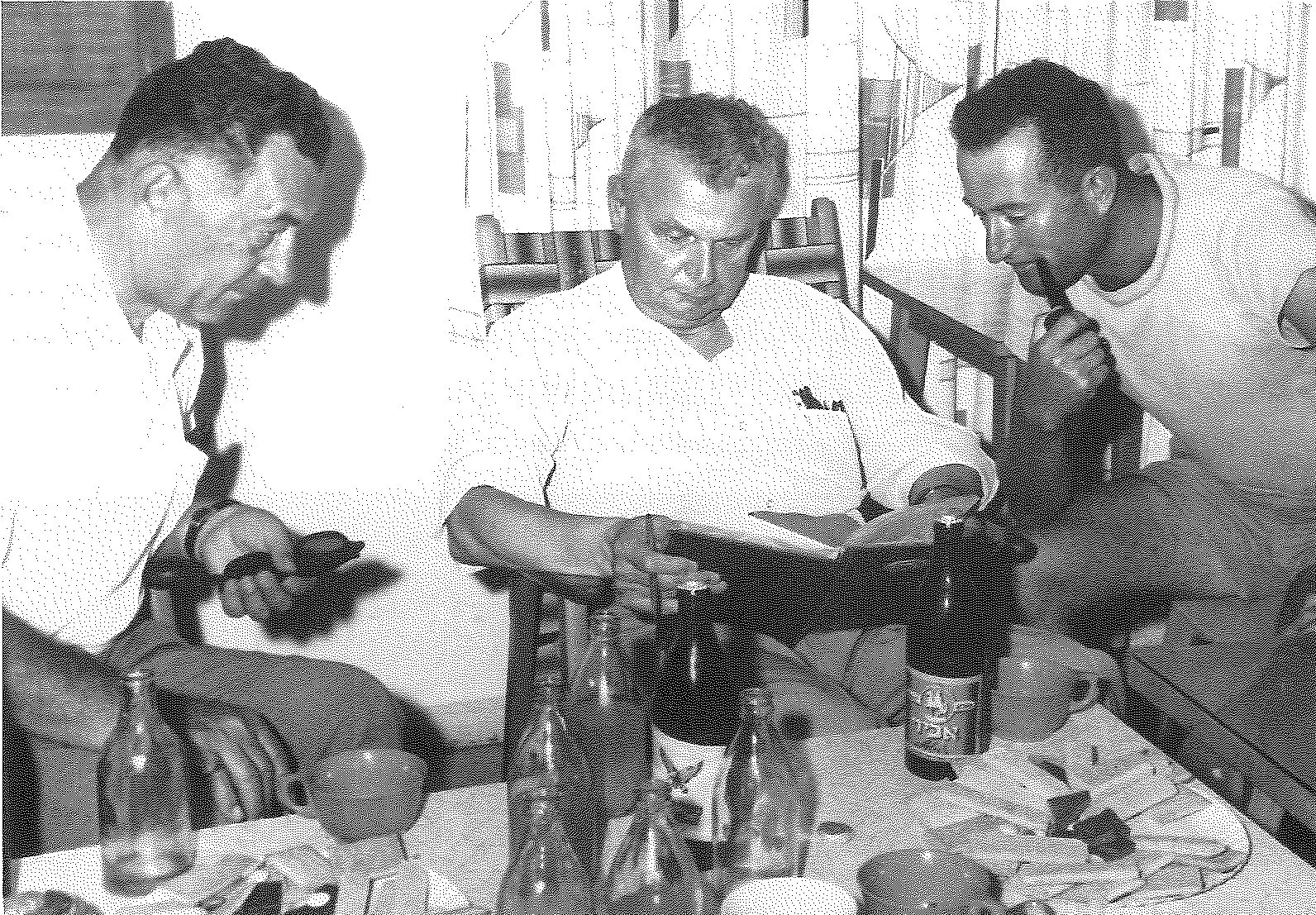 Tel Kazir — Saskatchewan teetotaller Diefenbaker viewing kibbutz scrapbook — (left to right) Norman Genzer, John Diefenbaker, and Kibbutz Chairman puffing on pipe.