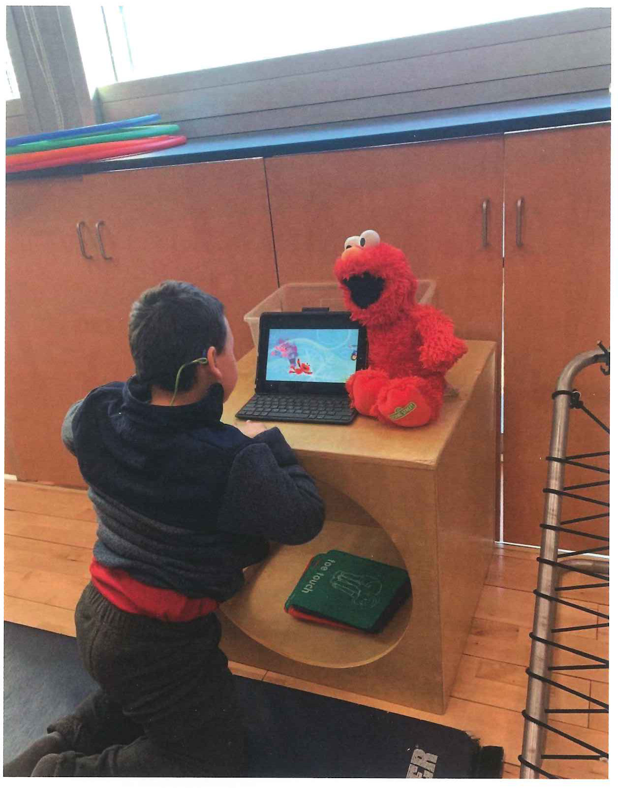 Zachy enjoying a bit of Elmo at school during downtime.